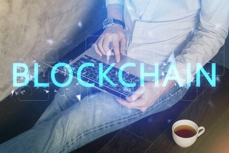 Crypto currency theme hologram with businessman working on computer on background. Concept of...