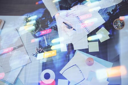 Double exposure of writing hand on background with data solution technology hologram. Ai concept.の写真素材