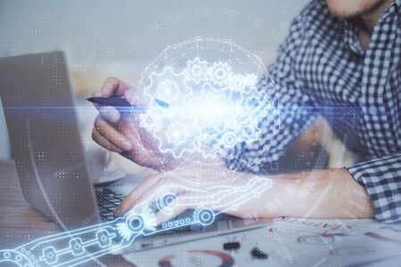 Businessman with computer background with technology theme hologram. Concept of hightech. Multi...
