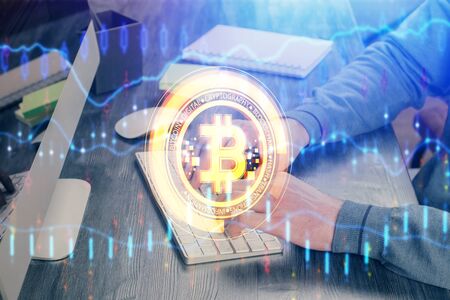 Crypto currency theme hologram with businessman working on computer on background. Concept of blockchain. Multi exposure.の写真素材