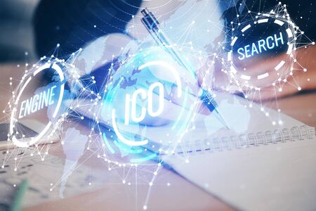 Cryptocurrency hologram over woman's hands writing background. Concept of blockchain. Multi exposureの写真素材