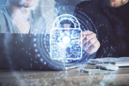 Multi exposure of lock icon with man working on computer on background. Concept of network protection.の写真素材