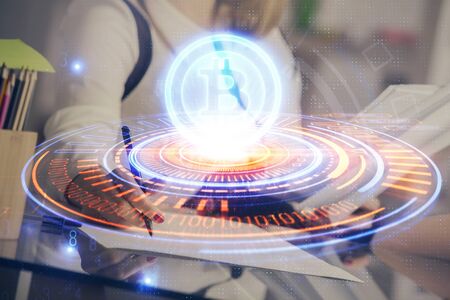Cryptocurrency hologram over woman's hands writing background. Concept of blockchain. Double exposureの写真素材