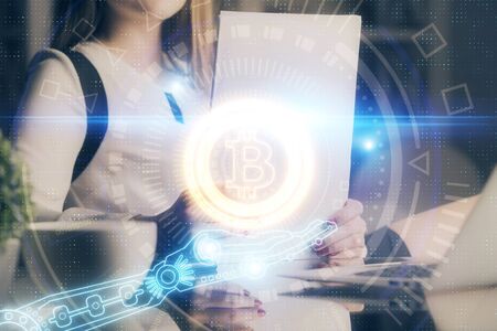 Cryptocurrency hologram over woman's hands writing background. Concept of blockchain. Double exposureの写真素材
