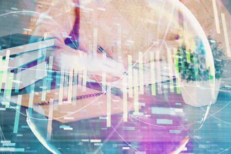 International business hologram over woman's hands taking notes background. Concept of success. Double exposureの写真素材