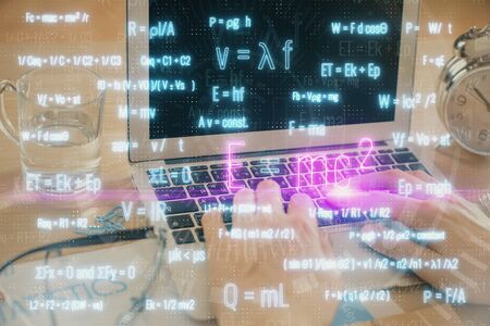 Science formula hologram with man working on computer on background. Education concept. Double exposure.の写真素材