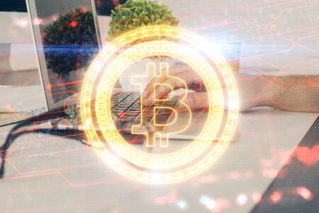 Crypto currency theme hologram with businessman working on computer on background. Concept of blockchain. Multi exposure.の写真素材