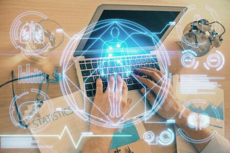 Science hologram with man working on computer on background. Concept of study. Double exposure.の写真素材