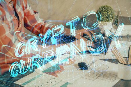 Crypto currency theme hologram with businessman working on computer on background. Concept of...