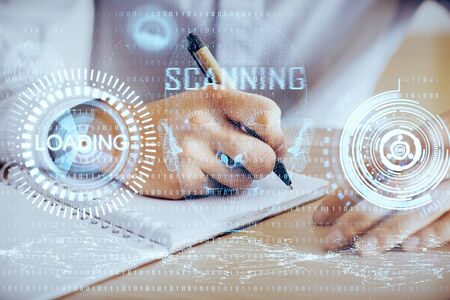 Writing mans hand with technology icons.の写真素材