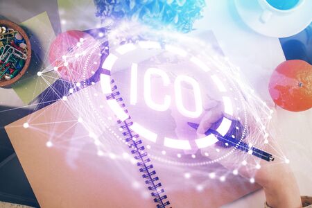 Cryptocurrency hologram over woman's hands writing background. Concept of blockchain. Multi exposureの写真素材