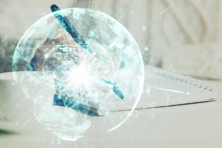 International business hologram over woman's hands taking notes background. Concept of success. Double exposureの写真素材
