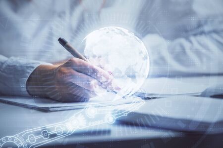 Multi exposure of hands making notes with world map hologram and data theme icons. Concept of global data.の写真素材