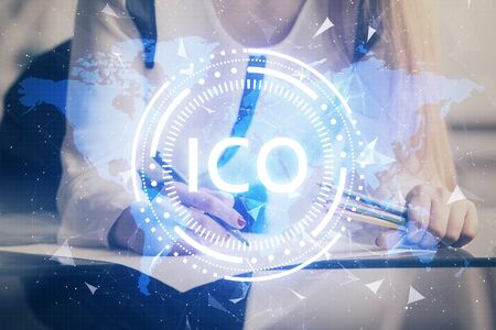 Cryptocurrency hologram over woman's hands writing background. Concept of blockchain. Double exposureの写真素材