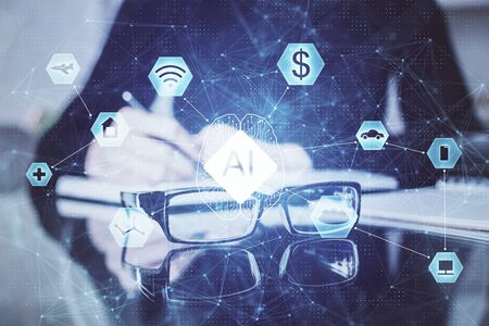 Double exposure of writing hands on background with data solution hologram on front. Technology...