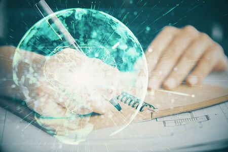 International business hologram over woman's hands taking notes background. Concept of success. Double exposureの写真素材