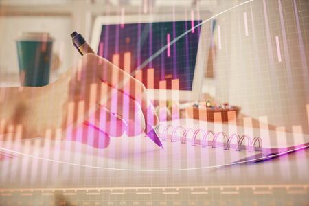 Financial forex graph drawn over hands taking notes background. Concept of research. Multi exposureの写真素材