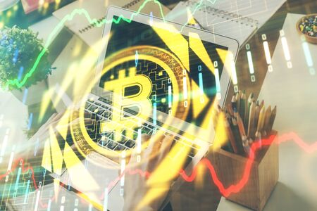 Crypto currency theme hologram with businessman working on computer on background. Concept of blockchain. Double exposure.の写真素材
