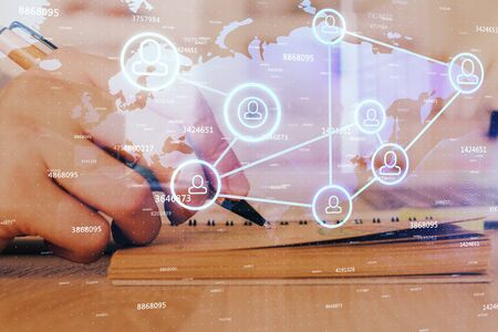 Man's hands working with notes background. Social networking scheme . Mixed media. Global business. Multi exposure.の写真素材