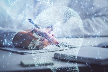 Double exposure of woman's writing hand on background with brain hologram. Concept of brainstorming.の写真素材