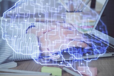 Man typing on keyboard background with brain hologram. Concept of big Data. Double exposure.の写真素材