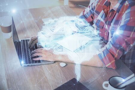 Man typing on keyboard background with brain hologram. Concept of big Data.の写真素材