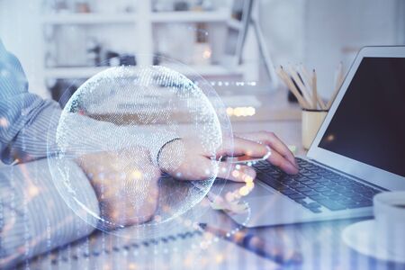 Multi exposure of world map hologram with man working on computer on background. Concept of worldwideweb.の写真素材