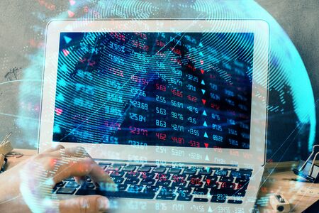 Double exposure of businessman working on laptop on background. International business hologram in front. Concept of success.の写真素材