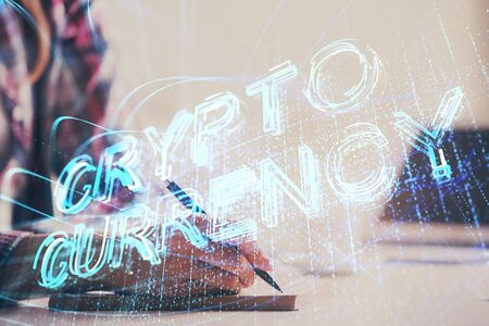 Cryptocurrency hologram over womans hands writing background. Concept of blockchain. Multi exposure