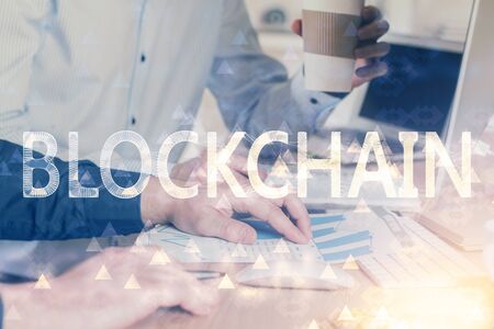 Crypto currency theme hologram with businessman working on computer on background. Concept of blockchain. Multi exposure.の写真素材