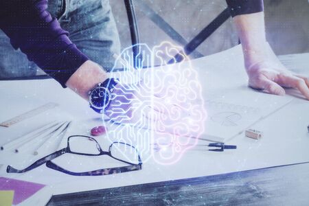 Man's hands withbrain double exposure drawing. Concept of human learning.の写真素材