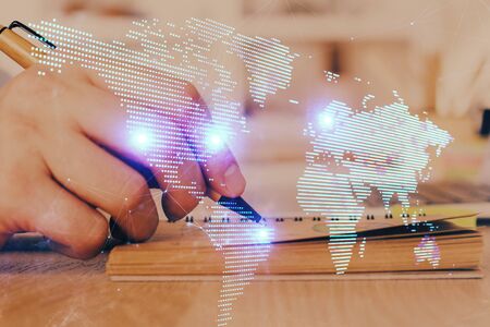 Man's hands working with notes background. Social networking scheme . Mixed media. Global business. Multi exposure.の写真素材