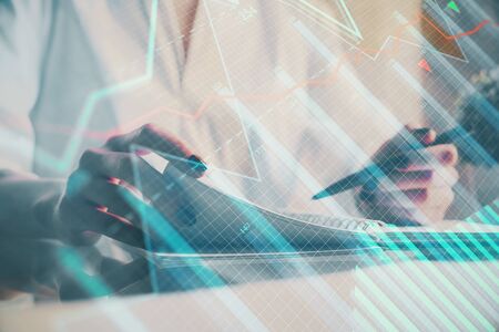 Financial chart drawn over hands taking notes background. Concept of research. Multi exposure