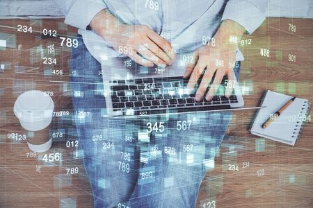 Multi exposure of technology hologram with man working on computer background. Concept of big data.の写真素材