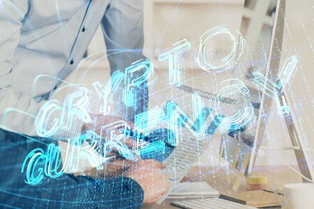 Crypto currency theme hologram with businessman working on computer on background. Concept of blockchain. Multi exposure.の写真素材