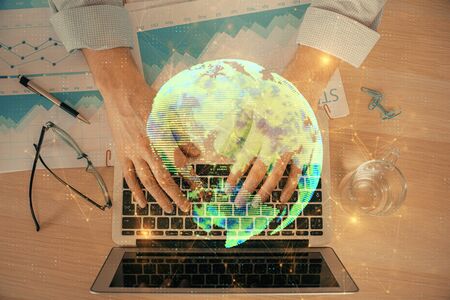 Social network theme hologram with businessman working on computer on background. Concept of world wide web. Double exposure.の写真素材