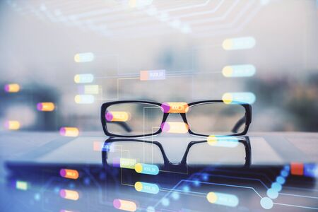 Data tech hologram with glasses on the table background. Concept of technology. Double exposure.