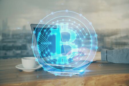 Crypto currency theme hologram with businessman working on computer on background. Concept of blockchain. Double exposure.の写真素材