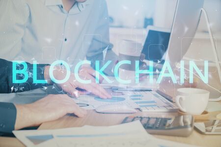Crypto currency theme hologram with businessman working on computer on background. Concept of...