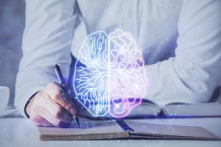 Man's hands withbrain double exposure drawing. Concept of human learning.の写真素材