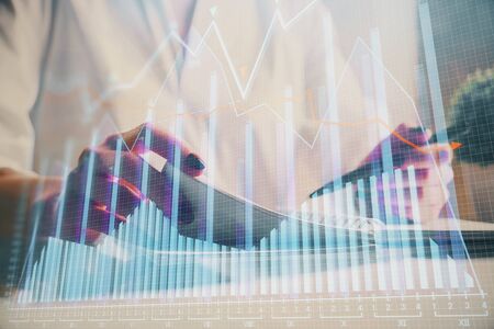 Financial chart drawn over hands taking notes background. Concept of research. Multi exposureの写真素材