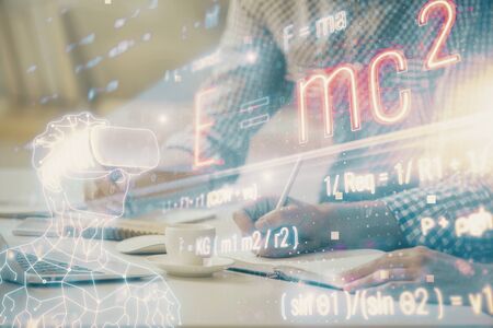 Science formula hologram with man working on computer on background. Education concept. Double exposure.の写真素材