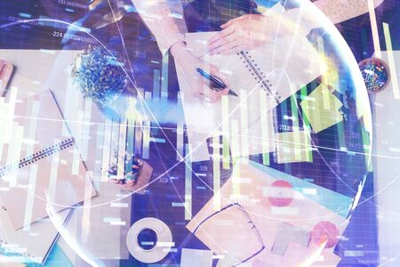 International business hologram over woman's hands taking notes background. Concept of success. Double exposureの写真素材