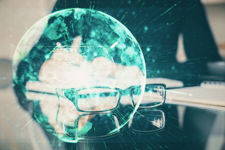 International business hologram over woman's hands taking notes background. Concept of success. Double exposureの写真素材