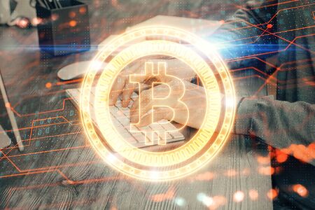 Blockchain theme hud with businessman working on computer on background. Concept of crypto chain. Double exposure.の写真素材