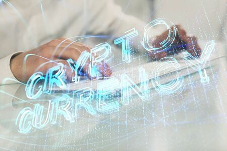 Crypto currency theme hologram with businessman working on computer on background. Concept of...