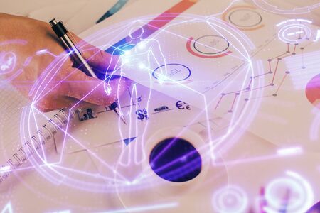 Man's hands working with notes background. Modern computer record diagram with virtual mnitor. Education concept. Double exposure.の写真素材