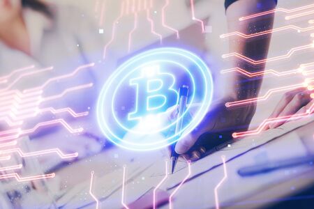 Cryptocurrency hologram over woman's hands writing background. Concept of blockchain. Multi exposureの写真素材