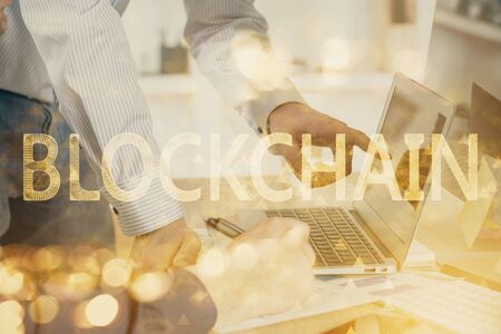 Crypto currency theme hologram with businessman working on computer on background. Concept of blockchain. Multi exposure.の写真素材