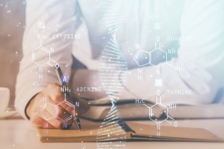 Mans hands working with notes background. Genetic engineering and gene manipulation concept.の写真素材